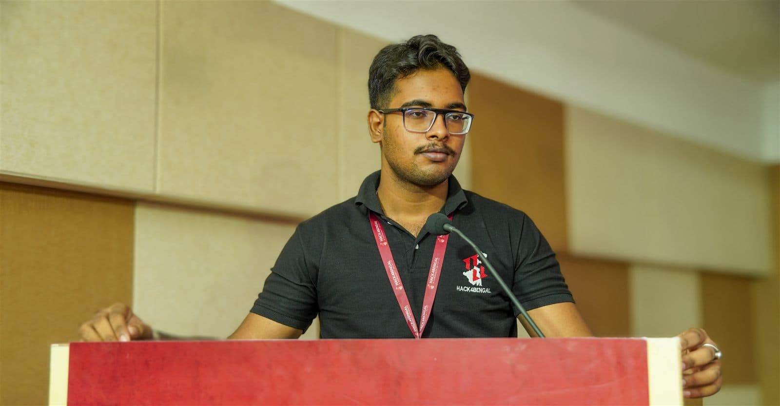 Abhirup Datta K. presenting at the HACK4BENGAL hackathon podium