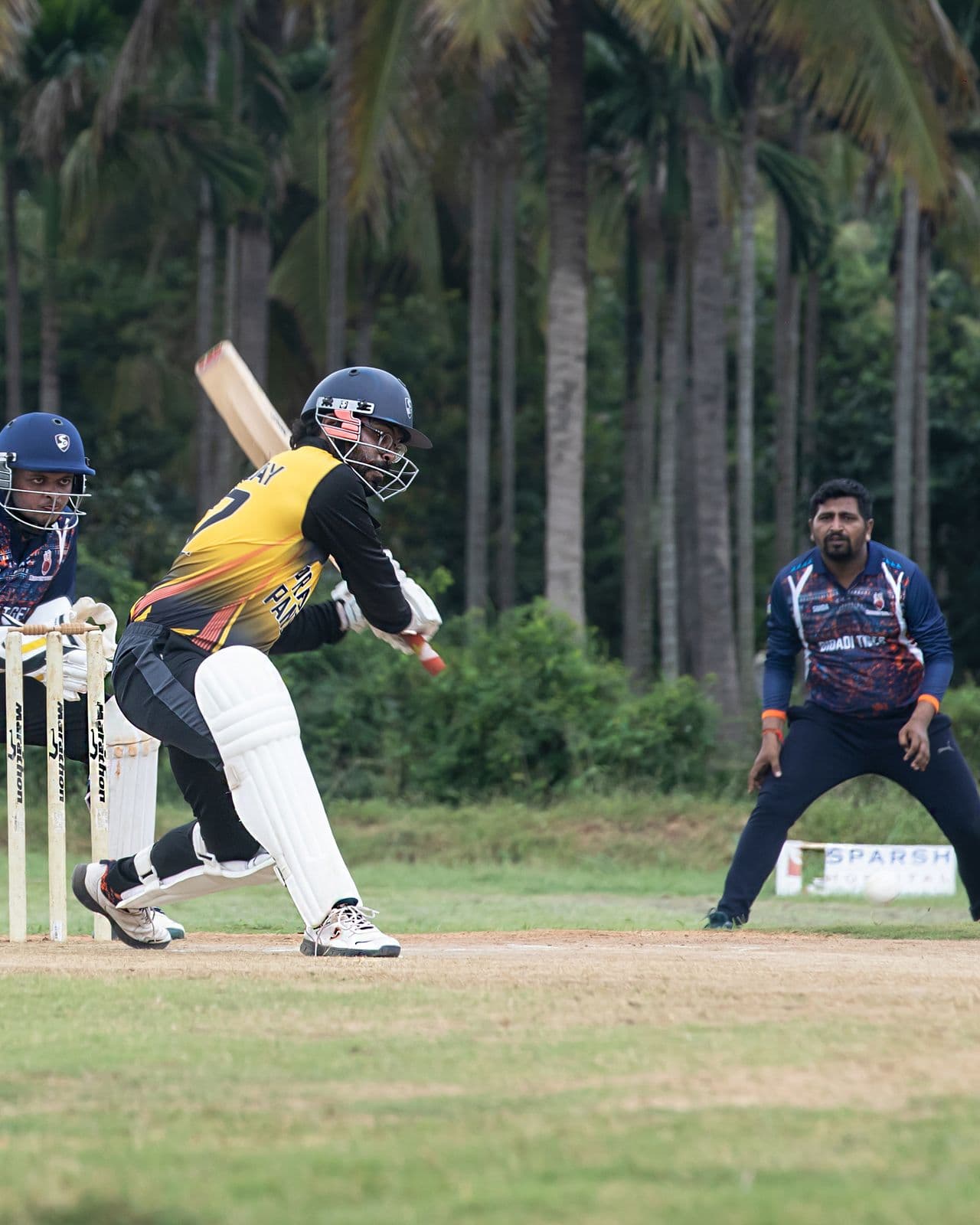 Cricket players in pads and gear gathering on the boundary before the start of a match